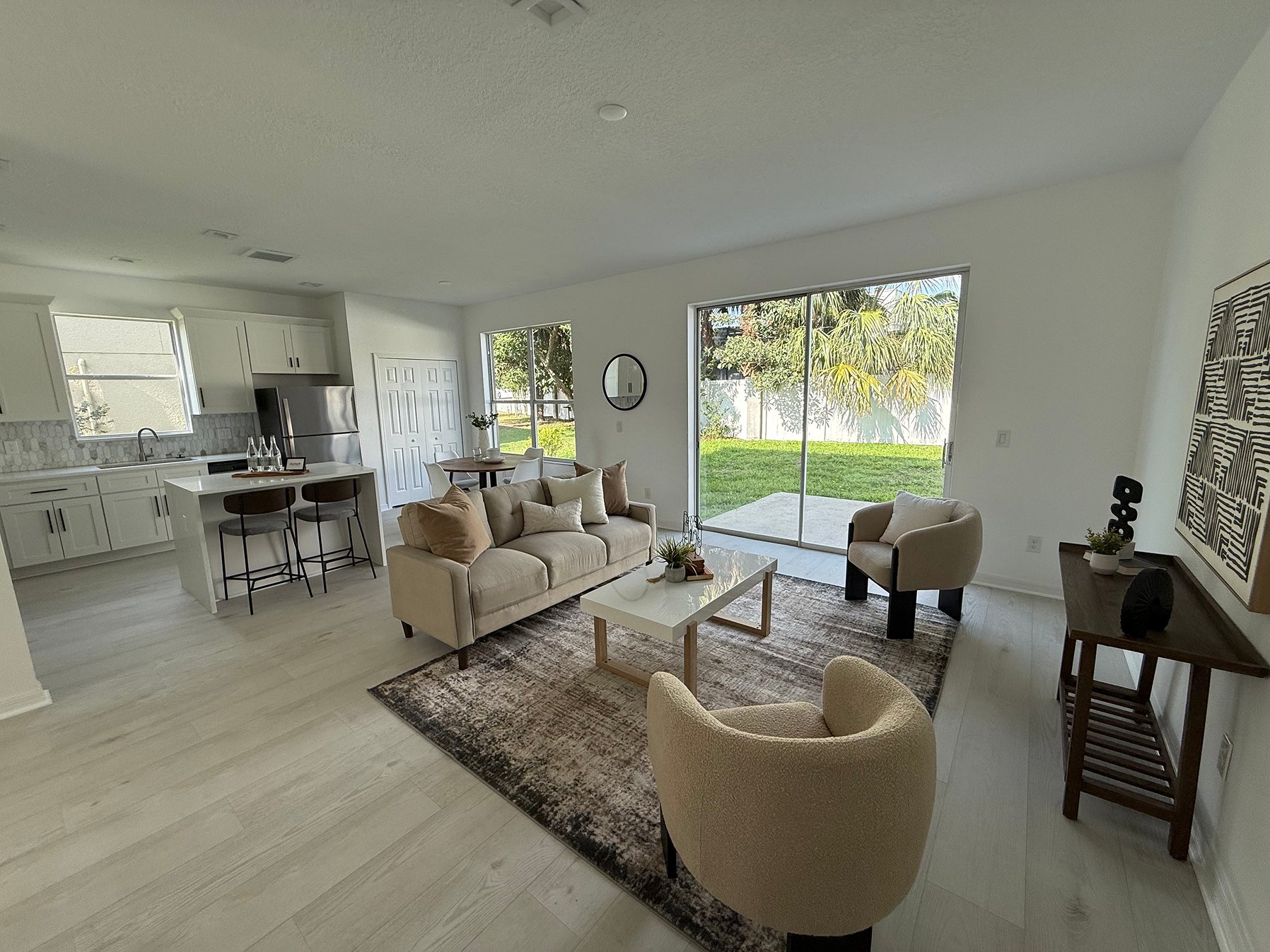Renovated open-plan kitchen and living room with sliding glass doors to the backyard
